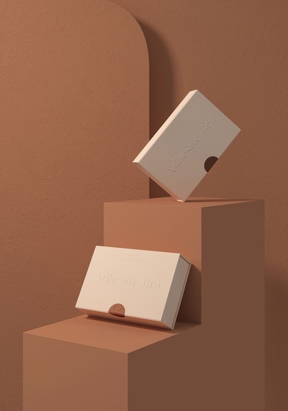 A high-end, studio-style product hero shot showcasing an Adhesive Bra box set against a complementary, architectural background to emphasize premium quality.